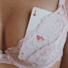 the back of a woman's bra with an ace playing card attached to it