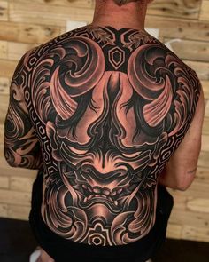 the back of a man with tattoos on his body