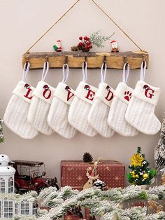 stockings hanging from a wooden rack with love written on them