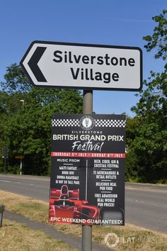 a sign for silverstone village in front of a road