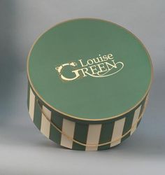 a green and white striped box with the words lounge green written in gold on it