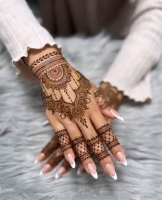 a woman's hand with hennap on it and her hands painted white