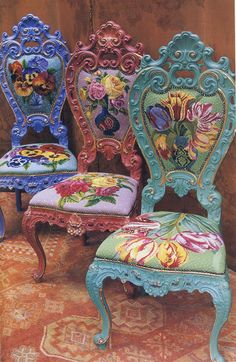 three chairs with floral designs on them sitting next to each other