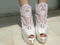 "White embellished lace boho wedding shoes for bride, custom shoe styles available. Winter weddings or boho chic weddings, these shoes compliment your white wedding dress beautifully! Custom wedding gift, personalized engagement gift. White satin bridal boots are designed with embroidered lace. Glass beads, shiny sequins and white pearls are used on the embroidery. The lace piece is tied with ribbons around the heels. Custom details can be added on this design, soles can be personalized with you Wedding Shoes Boho, Boots With Pearls, Wedding Shoes Ideas, Bridal Shoes Vintage, Cowgirl Boots Wedding, Brides Shoes, Boho Heels, Boho Wedding Shoes, Lace Bridal Shoes