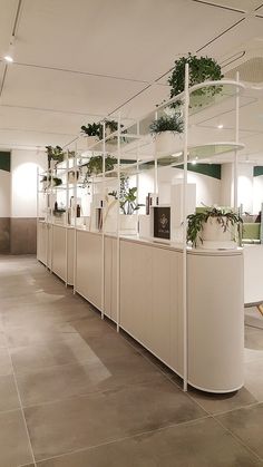 a row of white cabinets sitting next to each other on top of a tiled floor