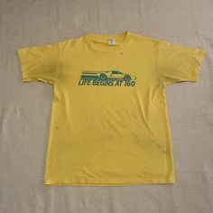 "Vintage '80s yellow graphic tee in thrashed condition  - Single stitch, 50/50 cotton/polyester blend, not quite paper thin but getting there! - Stains throughout-- looks like this guy was used as an oil rag 👌🏽 Measurements (taken flat): - Pit to pit: 20\" - Top to bottom: 26\" **PLEASE NOTE** This is a vintage item, which means it is 20+ years old, which means a few things: 1) There will most likely be at least a little wear & tear! 2) Tag sizes will not be accurate!  3) Its production date is oftentimes approximate! ...I do my best to describe each item as accurately as possible, but please expect a human-like margin of error. All sales are final, so please reach out with any questions before you purchase!" Yellow Graphic Tee, Ringer Tee, 20 Years Old, This Guy, 50 50, 20 Years, Graphic Tee, Graphic T Shirt, Men's Polo Shirt