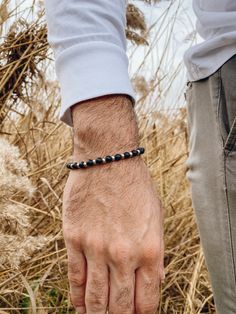 Men's bracelet with black beads and silver beads made from metal, passed through an elastic cord. In Christina Christi Jewels store you can see more than 50 designs in Men's Bracelets. You can have them in 2-4 Days with DHL EXPRESS SHIPPING - Black Beads - Metal Beads. - Metal Parts. - Elastic cord. - You can choose four different dimensions for your hand. * 17 cm - 6.6'' * 19 cm - 7.4'' * 21 cm - 8.2'' * 23 cm - 9.0'' In this link you can see my creations with section, Men's Bracelets: https:// Minimalist Silver Beaded Bracelet With Black Beads, Adjustable Black Bracelet With Silver Beads, Adjustable Black Stretch Bracelet With Silver Beads, Minimalist Black Hand-strung Bracelets, Minimalist Hand-strung Black Beaded Bracelets, Minimalist Black Hand-strung Beaded Bracelets, Minimalist Black Hand-strung Beaded Bracelet, Everyday Hand-strung Black Beaded Bracelets, Bracelet With Black Beads