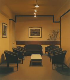 an empty waiting room with chairs and tables