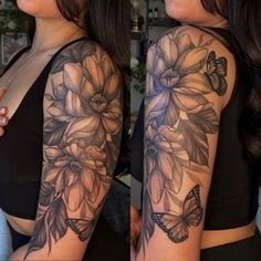 a woman's arm with flowers and butterflies on it, while she is wearing a black top