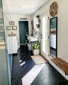 a bathroom with black and white tile flooring