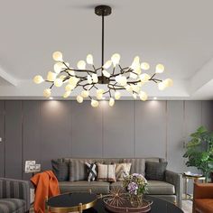 a living room filled with furniture and a chandelier hanging over the top of it