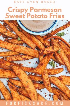 crispy parmesan sweet potato fries on a plate with dipping sauce in the background