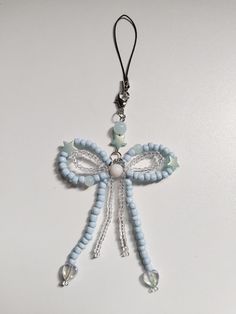 a blue and white beaded cross ornament