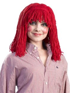 a woman with red hair wearing a plaid shirt