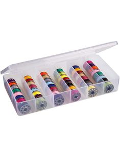 an open plastic box filled with lots of different colored spools