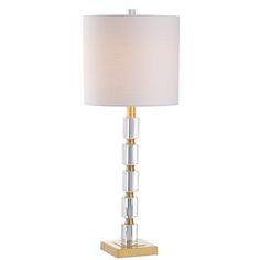 a table lamp with a white shade on the top and gold trimming around it