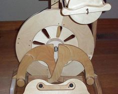 a wooden toy with wheels and hats on it