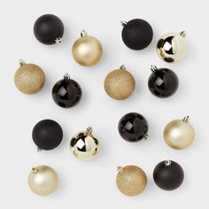 black and gold ornaments are arranged on a white surface