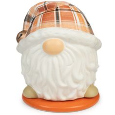 a close up of a santa clause figurine on an orange base with a white beard