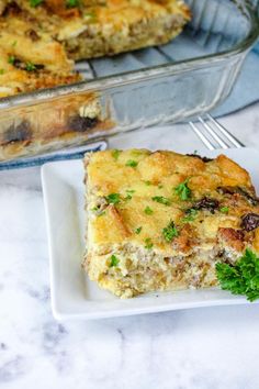 a piece of casserole on a plate with a fork next to the casserole