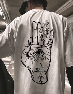 a person wearing a t - shirt with a hand drawn on it