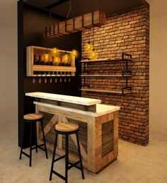 a bar with two stools next to it and a brick wall in the background