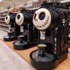 two coffee machines decorated with jack skellings and faces on display in a store