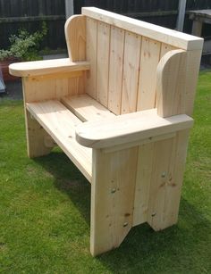 a wooden bench sitting on top of a lush green field