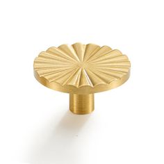 an image of a gold knob on a white background in the shape of a flower