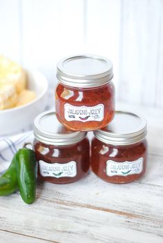 three jars of jalapeno jelly sitting on top of a table