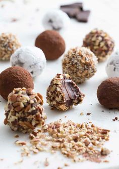 assorted chocolates and nuts on a white surface