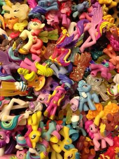 a pile of little pony toys sitting next to each other