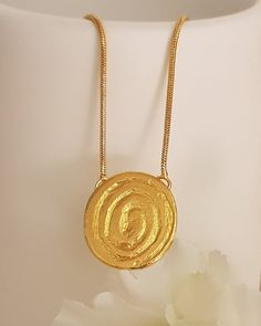 18K gold plated tribal spiral pendant necklaceThis simple design is perfect for every day, layered or worn alone.Lovely as a bridesmaids gift or as wedding jewelry! Each necklace will arrive in a black gift box. Spring clasp closure on 2 mm chainPendant Height: 20 mmPendant Width: 18 mmThe gold plating is a high quality 3 microns 18k gold thickWeight: 5 GramModel is shown with 17-inch chainSelect chain length at checkoutThis Necklace has Matching earrings: https://etsy.me/2V4iYHHSKU TP0147Custom Bohemian Yellow Gold Necklace With Large Pendant, Brass Necklaces With Detachable Pendant, Brass Necklace With Detachable Round Pendant, Elegant Brass Coin Necklace With Large Pendant, Bohemian Style Gold Round Temple Necklace, Bohemian Style Gold Temple Necklace, Bohemian Gold Temple Necklace, Gold Bohemian Temple Necklace, Gold Oval Pendant Necklace