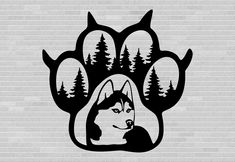 a black and white dog paw with trees on it's side, in front of a