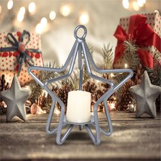 a silver star candle holder next to christmas decorations