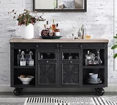 a bathroom with a sink, mirror and black cabinet