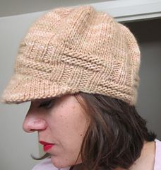 a woman wearing a knitted hat looking at her cell phone