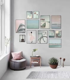 a living room with pictures on the wall and a chair next to a potted plant