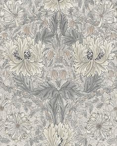 an intricately designed wallpaper with large flowers and leaves on the side, in grey and white