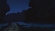 a train track is shown at night with the moon in the sky and water behind it