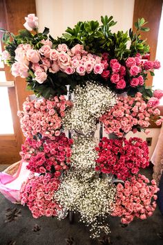 pink and white flowers are arranged in the shape of a letter