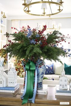 a vase filled with red, white and blue flowers sitting on top of a table