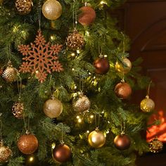 a christmas tree decorated with gold and silver ornaments