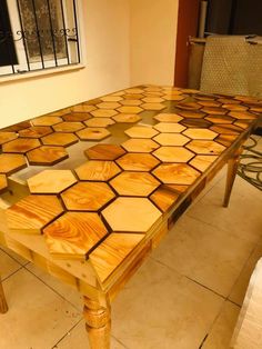 a wooden table sitting on top of a tiled floor