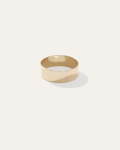 a gold ring with a thin band on the inside of it, against a white background