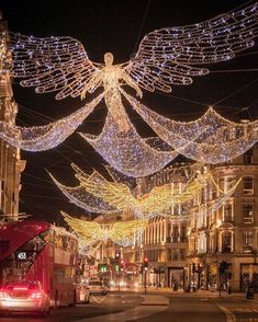 a city street decorated with christmas lights and angel decorations