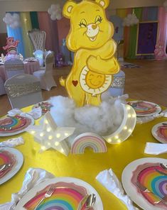 there is a table set up with plates and napkins for children's birthday party