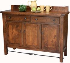 a wooden cabinet with two vases and an apple on top