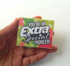 someone is holding up a pin with the words you're an extra special pioneers