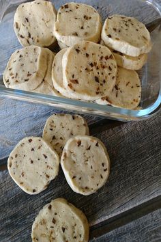 several cookies in a glass dish on a wooden table